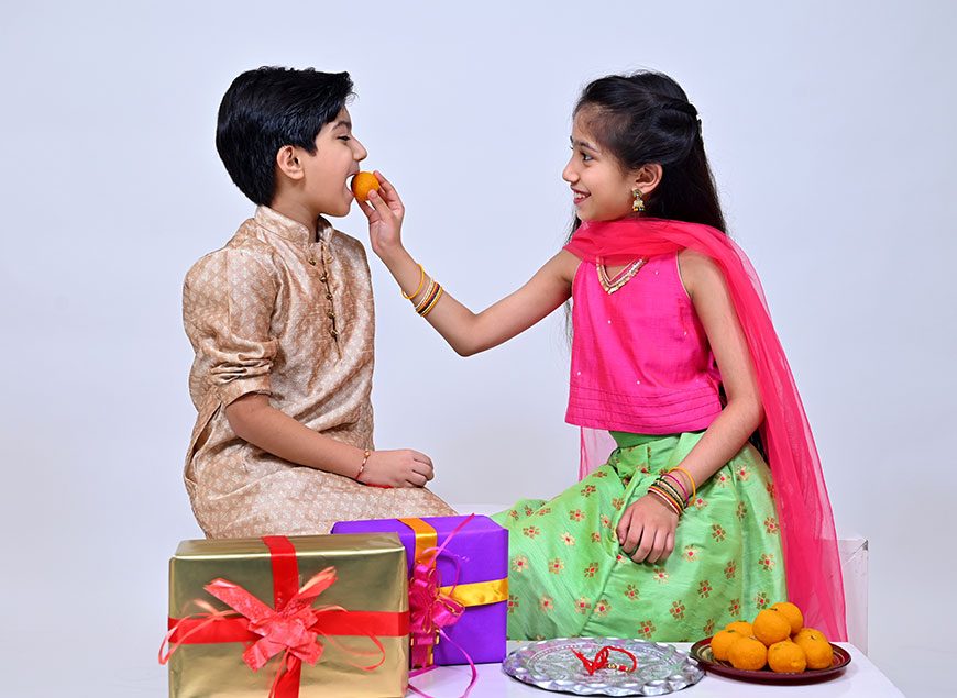 Raksha Bandhan / Rakshabandhan Rakhi with Haldi Kumkum rice, sweet Mithai,  Gift Box, selective focus Stock Photo - Alamy